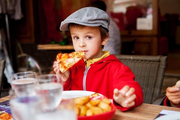 Boy eating pizza