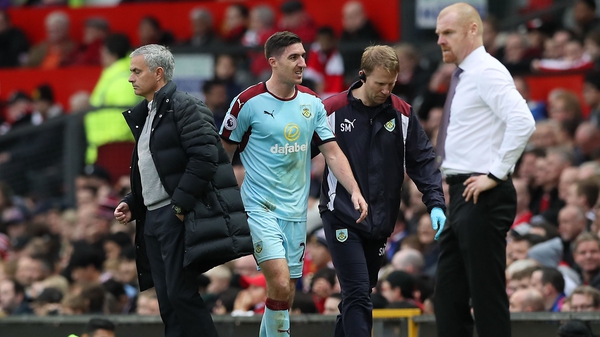 Burnley's Stephen Ward leaves the field of play with an injury