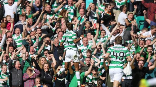 Goal-scorer Sinclair rushes to celebrate in front of the Celtic fans