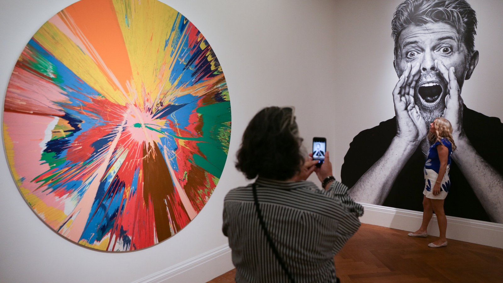 Two gallery assistants pose with Air Power by Jean-Michel Basquiat  News Photo - Getty Images