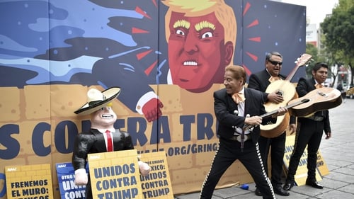 Mexican activists protest against Donald Trump in front of a specially made scenery wall in Mexico City