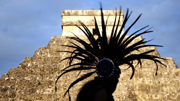 An indigenous man looks at Kukulkan pyramid as takes part in a ritual in Chichen Itza