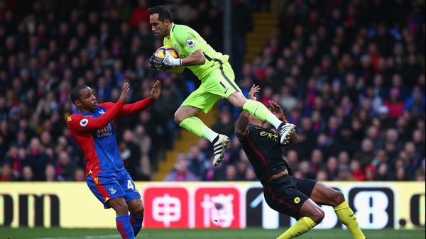 Vincent Kompany (R) is clattered by Claudio Bravo