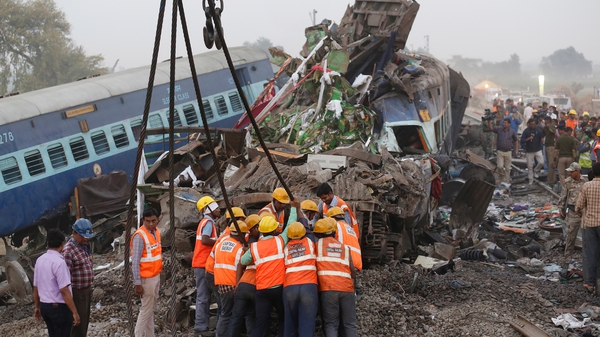 Rescue workers at the site of the accident near Pukhrayan, in Kanpur, India