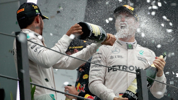 Lewis Hamilton sprays Nico Rosberg with champagne on the podium in Brazil