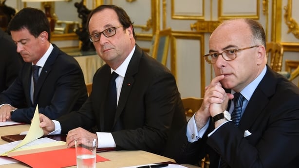 Hollande (2nd R), flanked by Bernard Cazeneuve (R) and Manuel Valls