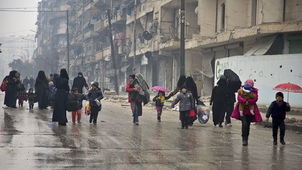 Civilians leave a rebel held area of Aleppo