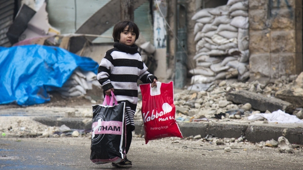 A Syrian child leaves a rebel-held area of Aleppo