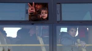 Syrians pictured on a bus out of eastern Aleppo