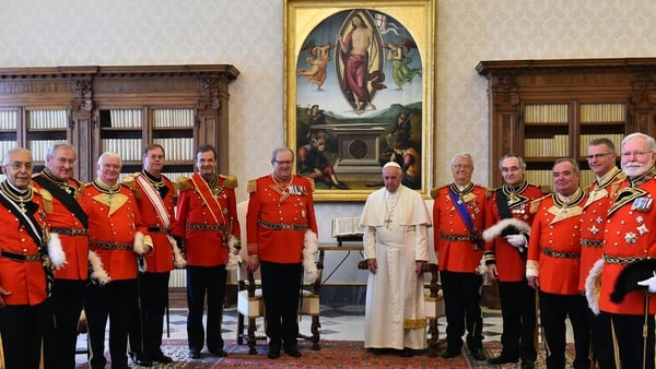 Pope Francis poses with a delegation from the Order of Malta at the Vatican in June