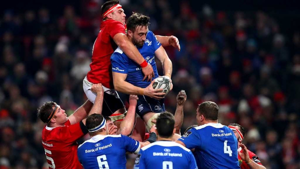 Munster's CJ Stander and Jack Conan of Leinster grapple for possession