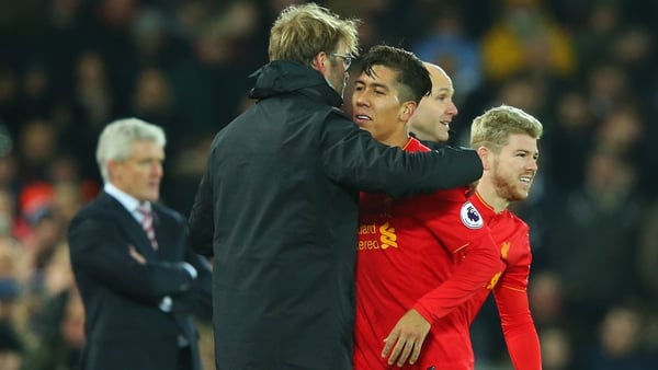 Klopp and Firmino embrace at the end of the 4-1 win over Stoke City