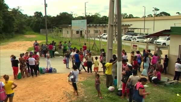 Crowds wait outside the prison in Manaus