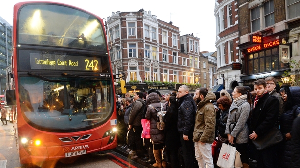 People queue for buses in central London