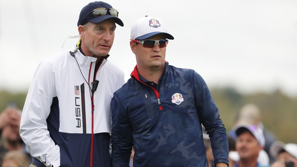 Jim Furyk (L) advising Zach Johnson as a vice-captain during the 2016 Ryder Cup