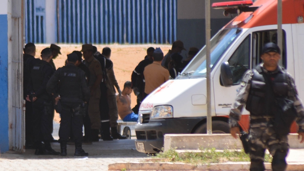 Authorities attend a wounded inmate inside the Alcacuz prison in Brazil