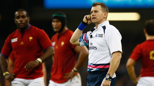 Rugby referee Nigel Owens waits to hear advice from a TMO regarding an important decision