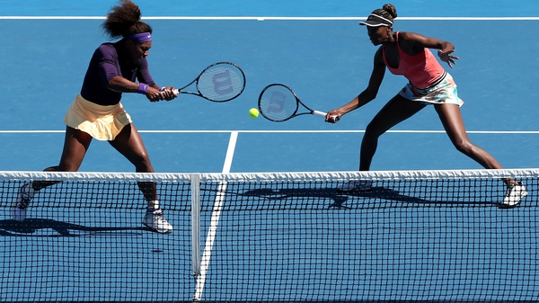 Serena (L) and Venus Williams will be on opposite sides of the net tomorrow
