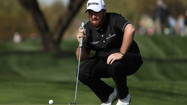 Shane Lowry lines up a putt on the ninth