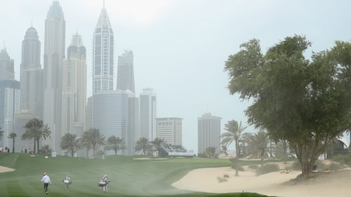 Strong winds create a mini-sandstorm on the eighth hole at Emirates Golf Club