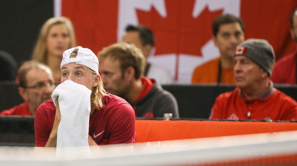 Denis Shapovalov reacts with disbelief after he hit the umpire with a ball unleashed in frustration