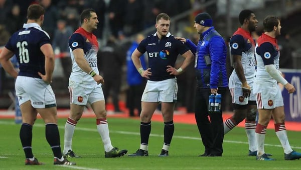 Stuart Hogg is consoled after the full-time whistle in Paris