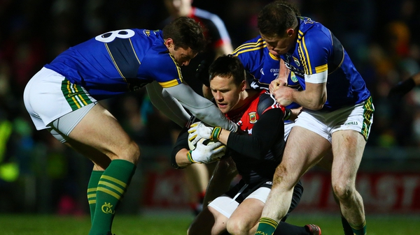 Kerry's David Moran, Mark Griffin and Tadhg Morley attempt to tackle Andy Moran