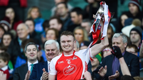 Mayfield's Shane O'Donovan lifts the cup on the steps of the Hogan Stand