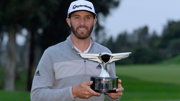 Dustin Johnson poses with the Genesis Open trophy