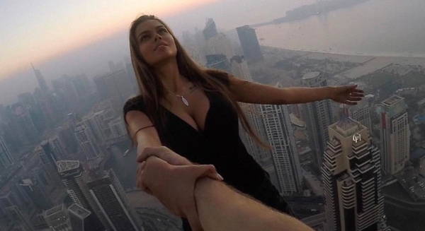 Russian model Viktoria Odintcova dangling over the edge of one of the world's tallest skyscrapers