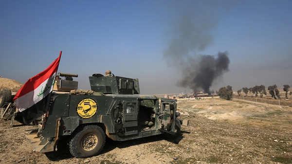 Smoke billows as Iraqi forces gather at Mosul airport during an offensive to retake the western side of the city