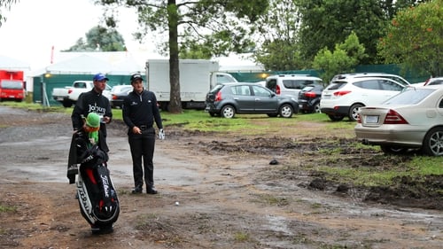 Paul Dunne contemplates a shot from a car park at the first today