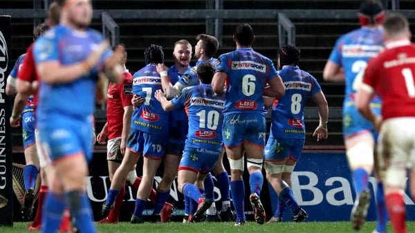 Johnny McNicholl is mobbed by his team-mates after scoring at Thomond Park