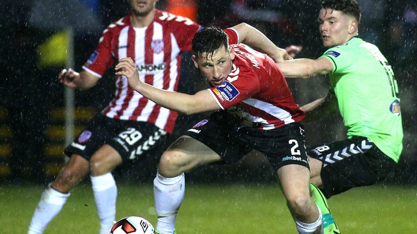 Conor McDermott and Dean Clarke battle for possession before the floodlight failure