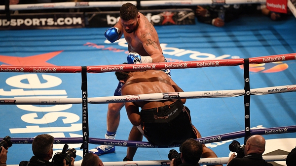Tony Bellew punches Boxer David Haye through the ropes to win their bout
