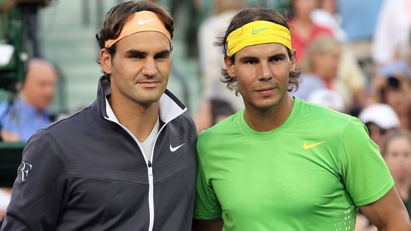 Roger Federer (L) and Rafael Nadal are more used to being on opposite sides of the net
