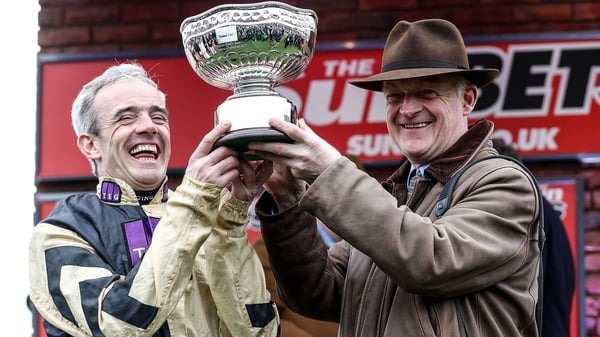 Ruby Walsh and Willie Mullins (R) celebrate with the Sun Bets Stayers' Hurdle trophy