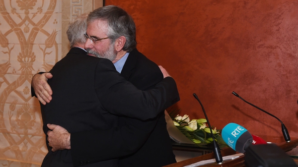 Martin McGuinness is embraced by Gerry Adams at a press conference in Belfast in January