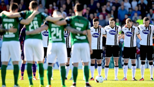 Cork City and Dundalk players observe a minute's silence for Ryan McBride
