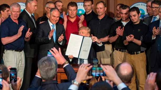 Donald Trump signs an executive order to undo climate change regulations