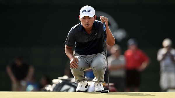 Kang Sung-hoon lines up a putt on the 18th