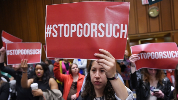 Activists hold placards against the nomination of Neil Gorsuch