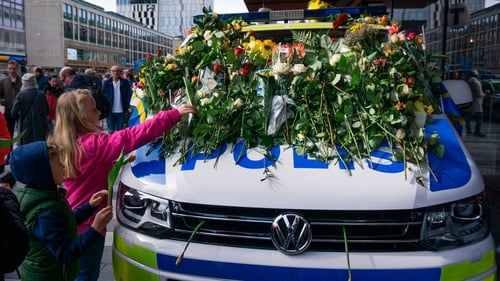 Several police cars parked near the scene were covered in flowers by Swedes, who widely praised the emergency crews' speedy response to the attack