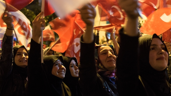 Supporters of Turkish President Erdogan celebrate as the results of the constitutional referendum are announced in Istanbul