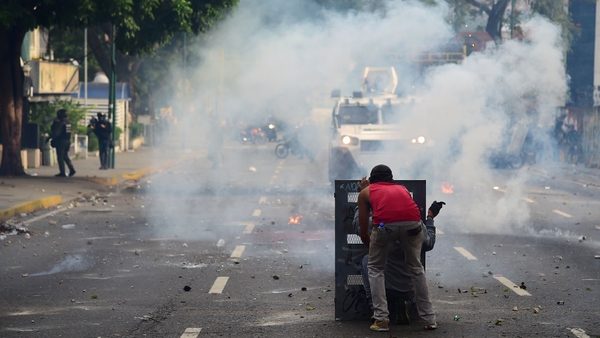 A demonstrator clashes with the police during a rally in Caracas