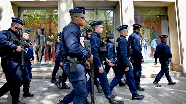 Armed police patrol the Champs Elysees in paris