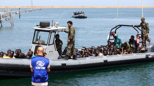 Migrants, rescued by the Libyan coastguard, arrive at the naval base in Tripoli