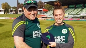 Mary Waldron is presented with her 100th cap by Andrew Poynter