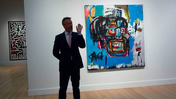A Sotheby's official speaks about the painting by Jean-Michel Basquiat during a media preview earlier this month