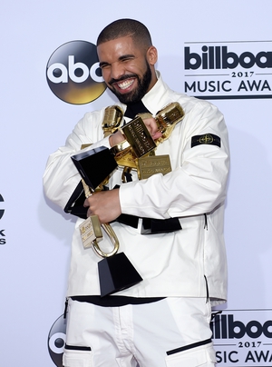 Wearing white and black, rapper Drake brought home gold at the Billboard Music Awards. The rapper won 13 awards in total on the night.